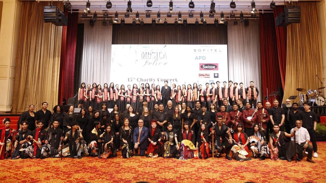 Close-up runway moment highlighting TATZU’s modern kimono silhouettes and dramatic stage lighting.