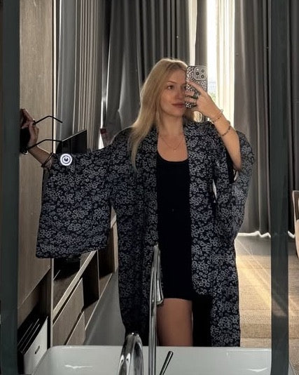 Mirror selfie of a customer wearing a black and white kimono remake haori.